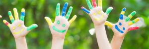 iStock image children painted hands in air